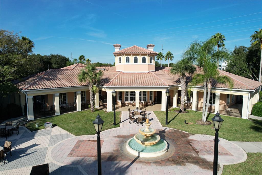 8762 Worldquest Boulevard, Unit 5103 Orlando, FL 32821 - Photo 26 of 30 a view of a patio with couches table and chairs and potted plants