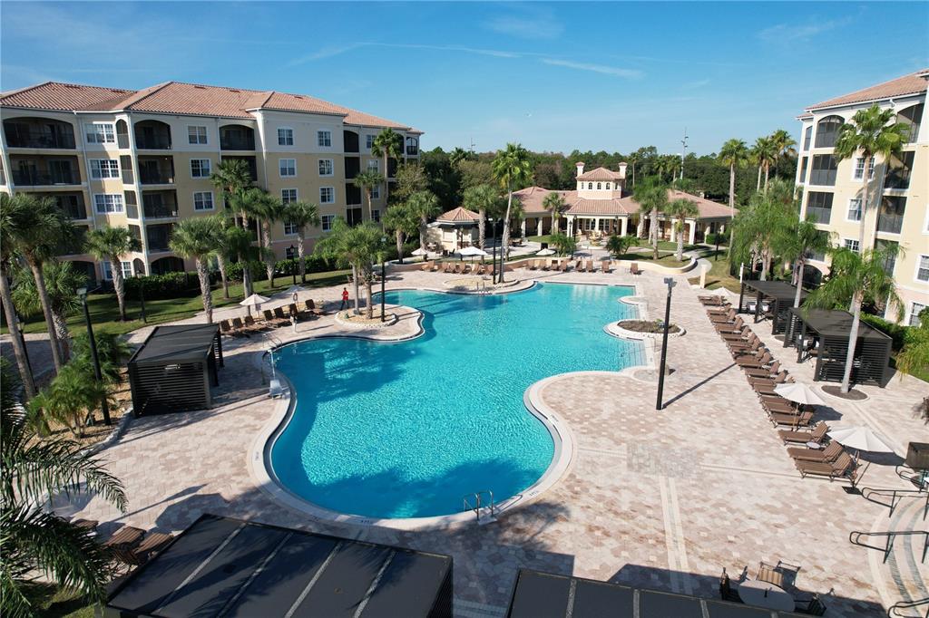 8762 Worldquest Boulevard, Unit 5103 Orlando, FL 32821 - Photo 27 of 30 a view of a swimming pool with outdoor seating