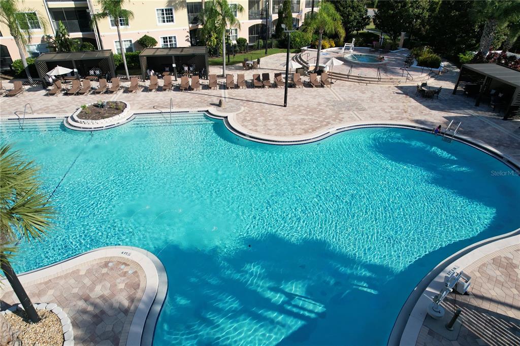 8762 Worldquest Boulevard, Unit 5103 Orlando, FL 32821 - Photo 28 of 30 a swimming pool with outdoor seating and yard