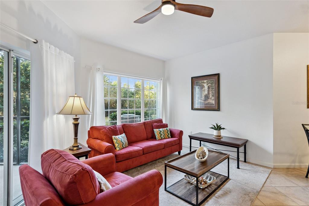 8762 Worldquest Boulevard, Unit 5103 Orlando, FL 32821 - Photo 5 of 30 a living room with furniture and a window