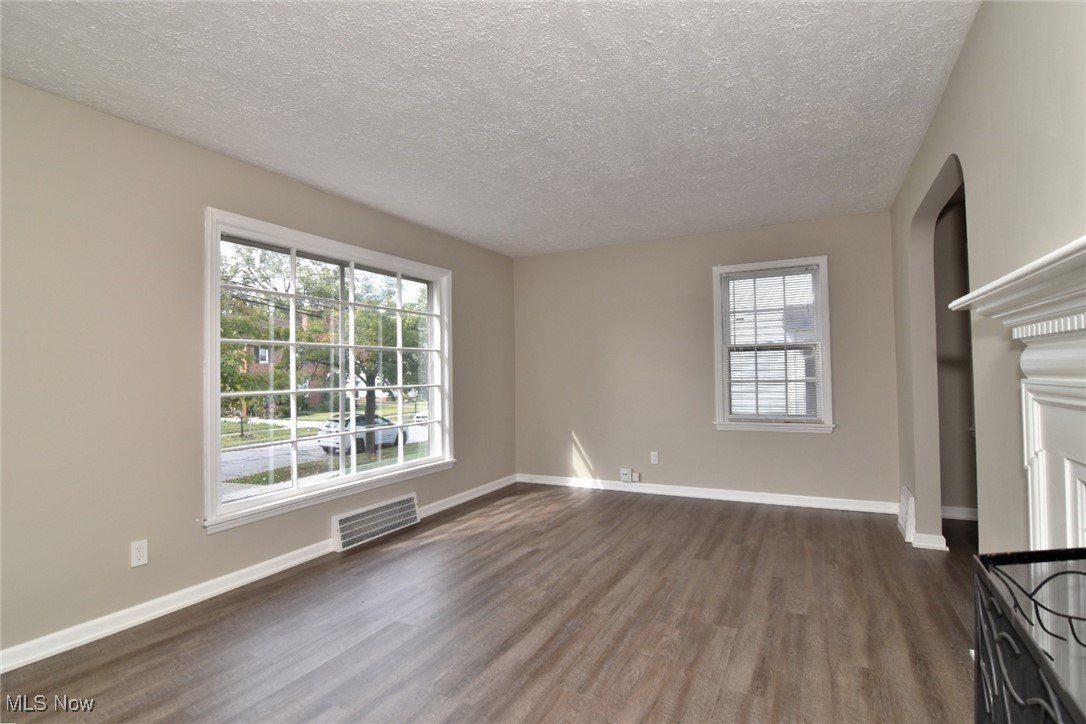 1443 Churchill Road Lyndhurst, OH 44124 - Photo 4 of 39 Unfurnished living room with dark wood finished floors and a textured ceiling