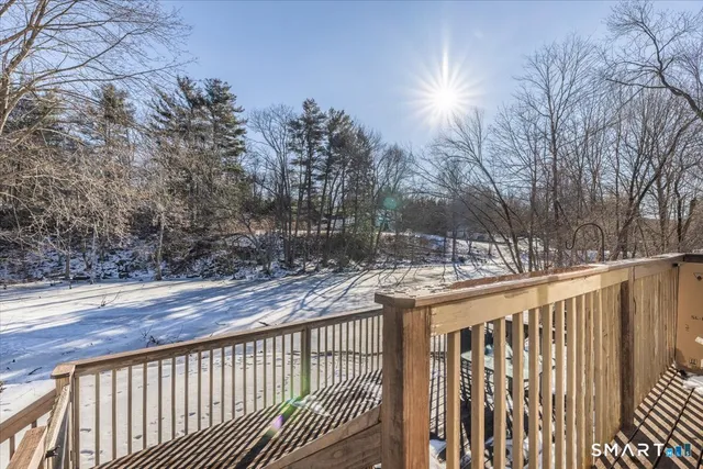 a view of a balcony with wooden fence and floor