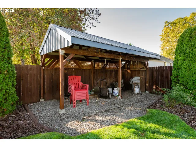a view of a house with a small yard and wooden fence