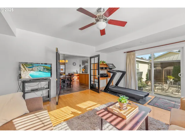 a living room with furniture a rug and a flat screen tv
