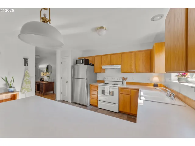 a kitchen with a stove a refrigerator and a sink