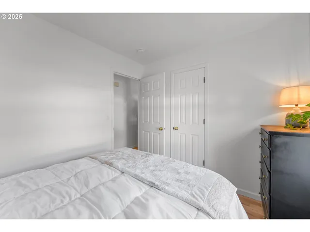 a bedroom with a bed and a lamp