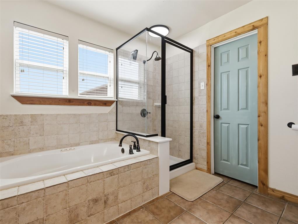 3823 State Highway Bonham, TX 75418 - Photo 16 of 37 a bathroom with a bathtub and a shower