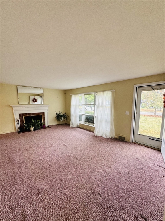 80 Jeffrey Road Springfield, MA 01119 - Photo 8 of 32 an empty room with a fireplace and window