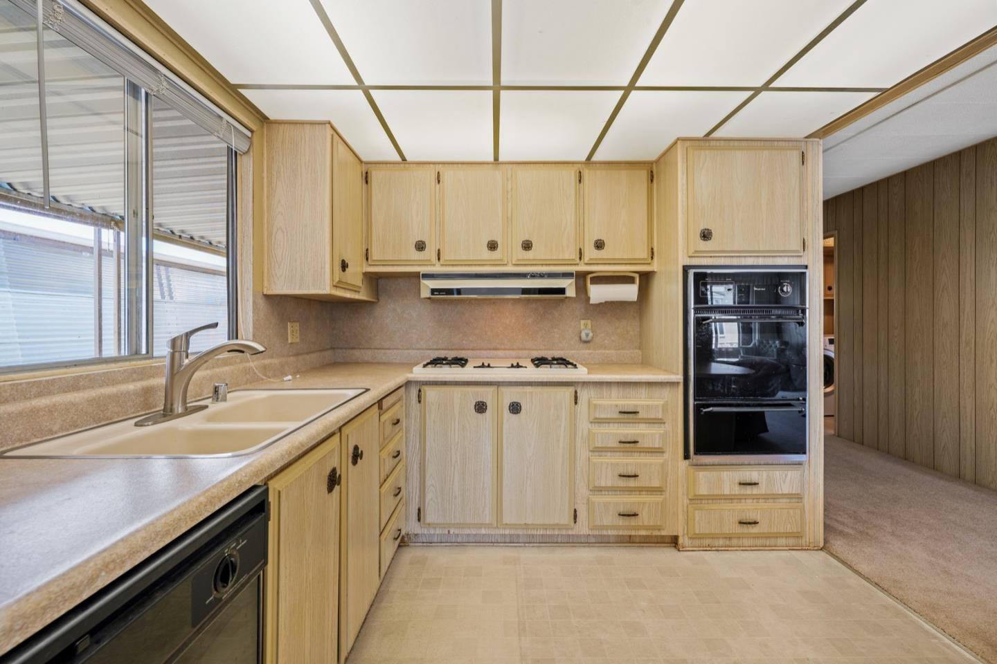 13 Primrose Street, Unit 13 Aptos, CA 95003 - Photo 8 of 15 a kitchen with white cabinets and appliances