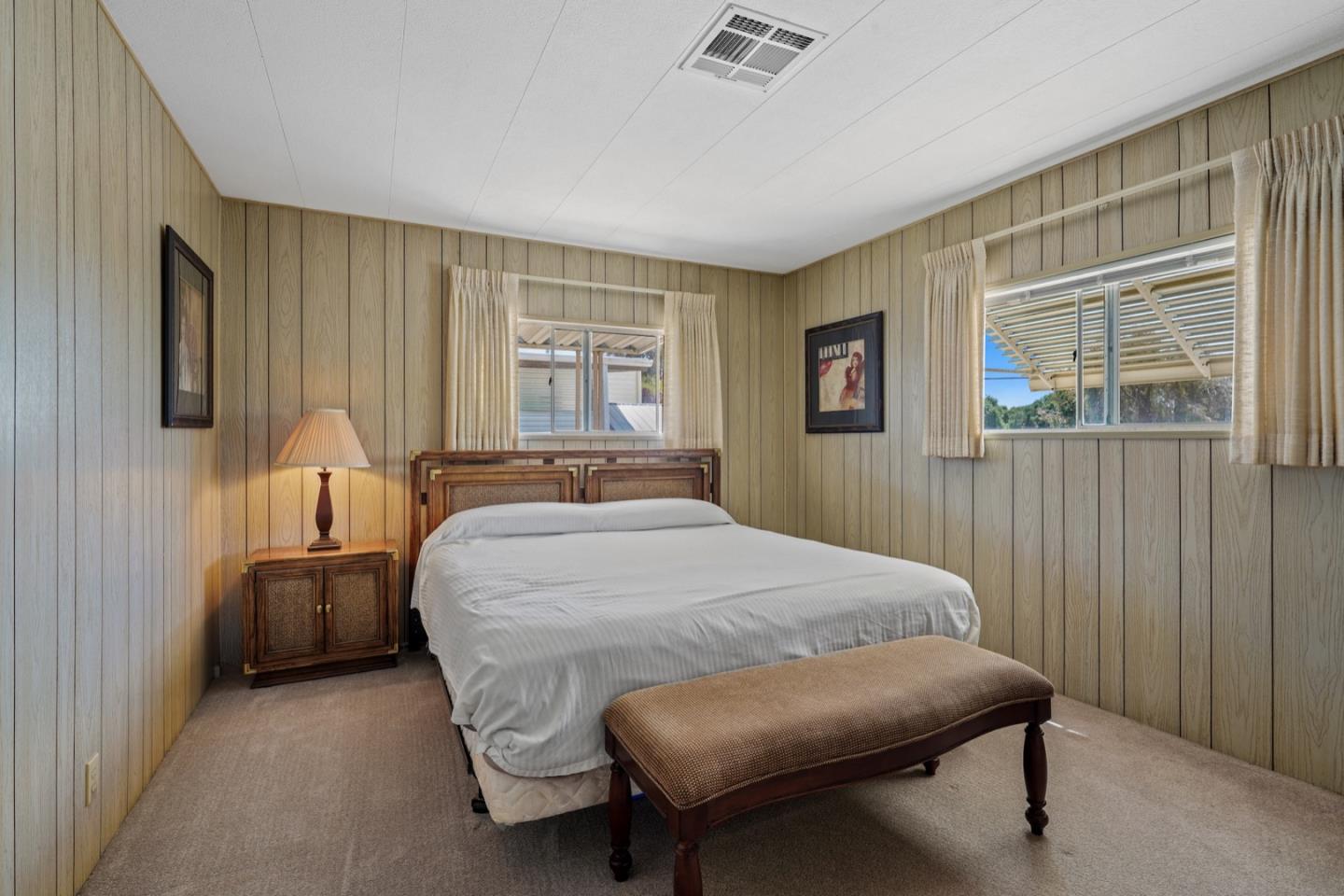 13 Primrose Street, Unit 13 Aptos, CA 95003 - Photo 9 of 15 a bedroom with a bed and wooden floor