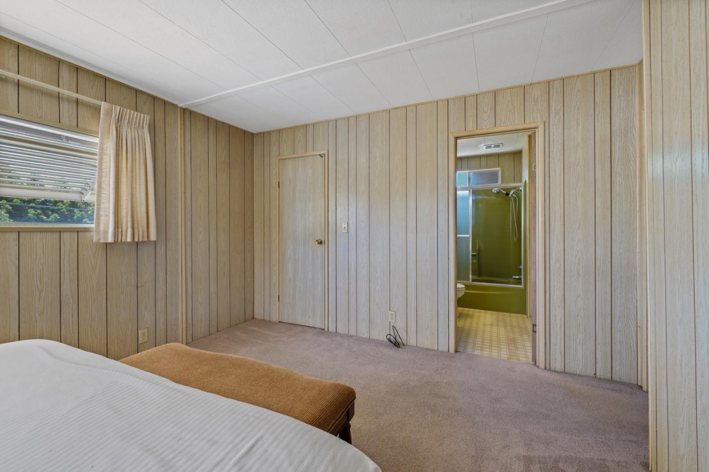 13 Primrose Street, Unit 13 Aptos, CA 95003 - Photo 10 of 15 a bedroom with a bed and a window
