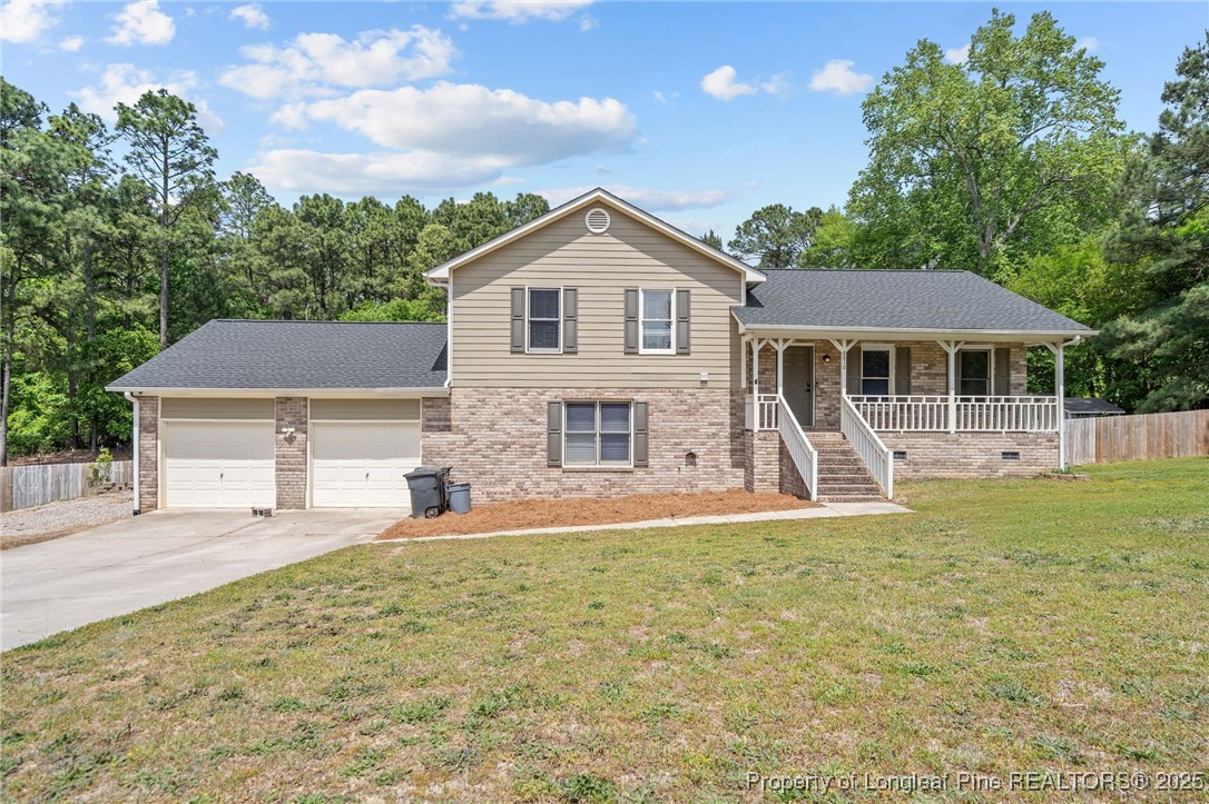 8810 Tangletree Drive Linden, NC 28356 - Photo 1 of 50 a front view of a house with a yard and garage