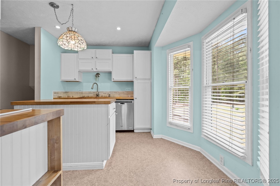8810 Tangletree Drive Linden, NC 28356 - Photo 12 of 50 a very nice looking kitchen with granite countertop a stove a sink a window and a dining table