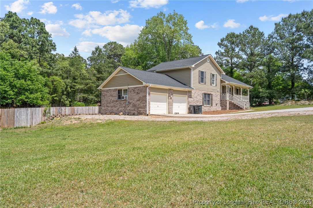 8810 Tangletree Drive Linden, NC 28356 - Photo 2 of 50 a front view of a house with a garden