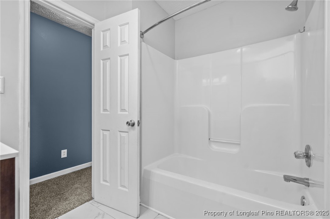 8810 Tangletree Drive Linden, NC 28356 - Photo 30 of 50 a bathroom with a bathtub and a shower