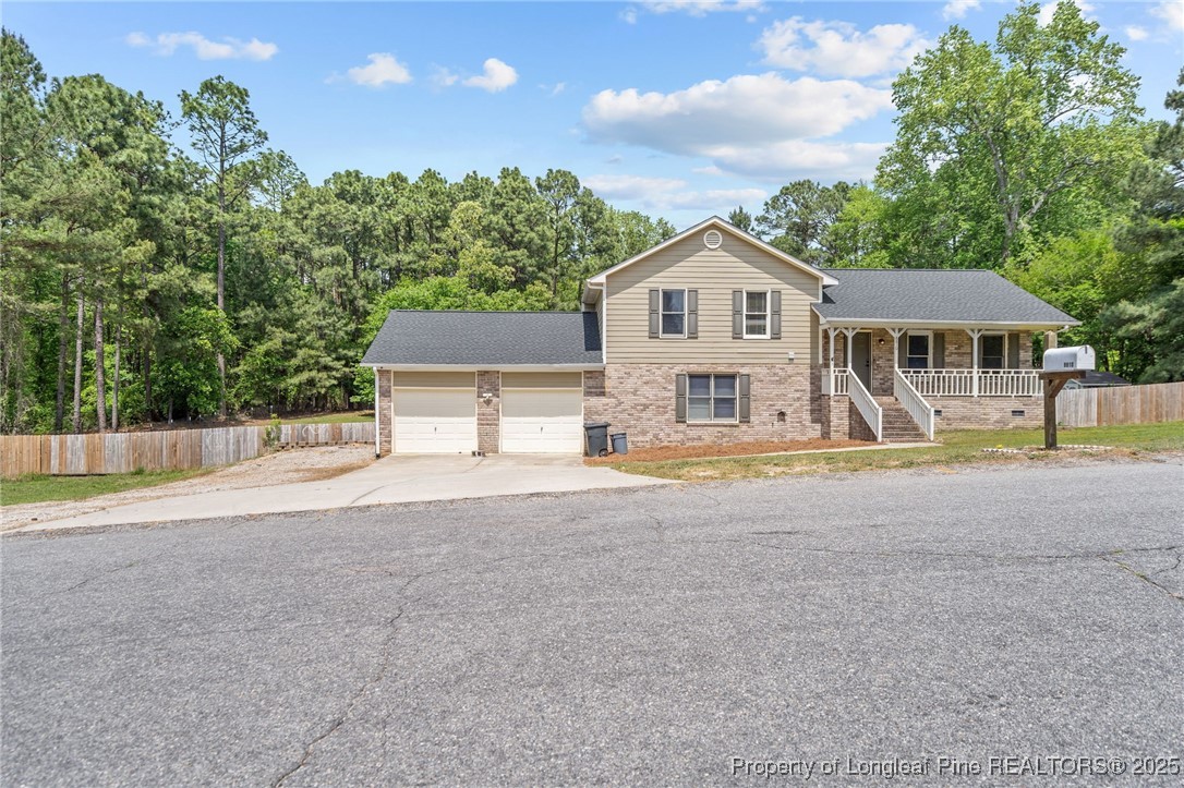 8810 Tangletree Drive Linden, NC 28356 - Photo 3 of 50 a front view of a house with a yard and trees
