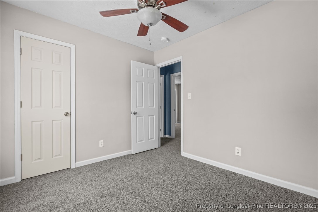 8810 Tangletree Drive Linden, NC 28356 - Photo 32 of 50 an empty room with a ceiling fan and a ceiling fan