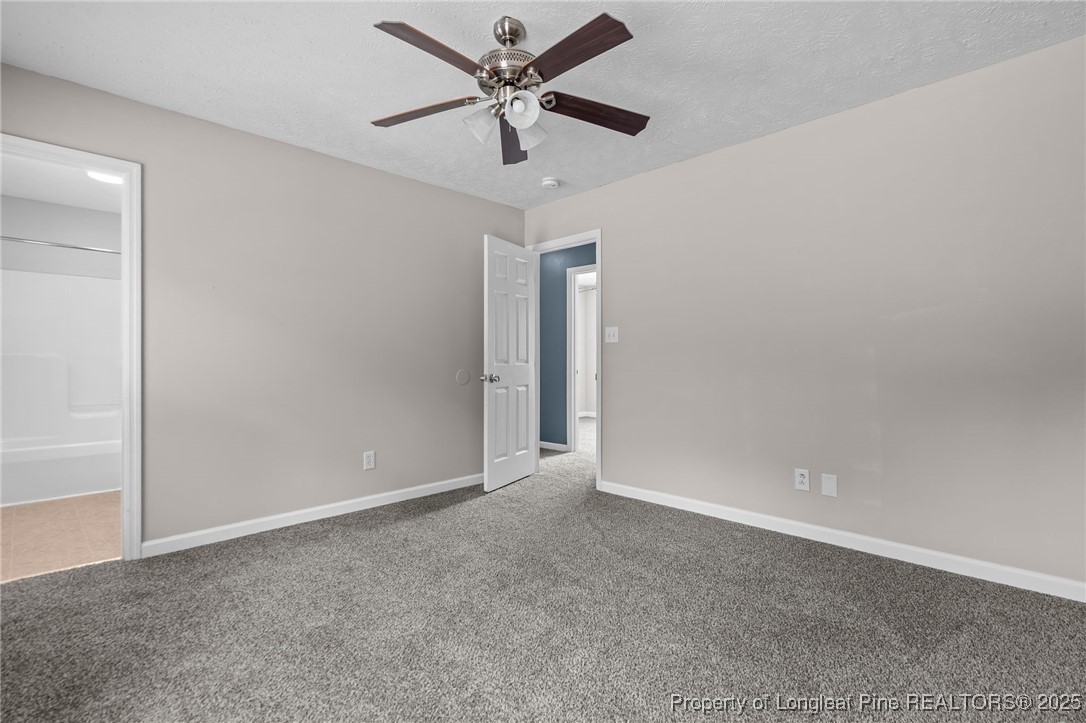 8810 Tangletree Drive Linden, NC 28356 - Photo 34 of 50 an empty room with closet and a chandelier fan