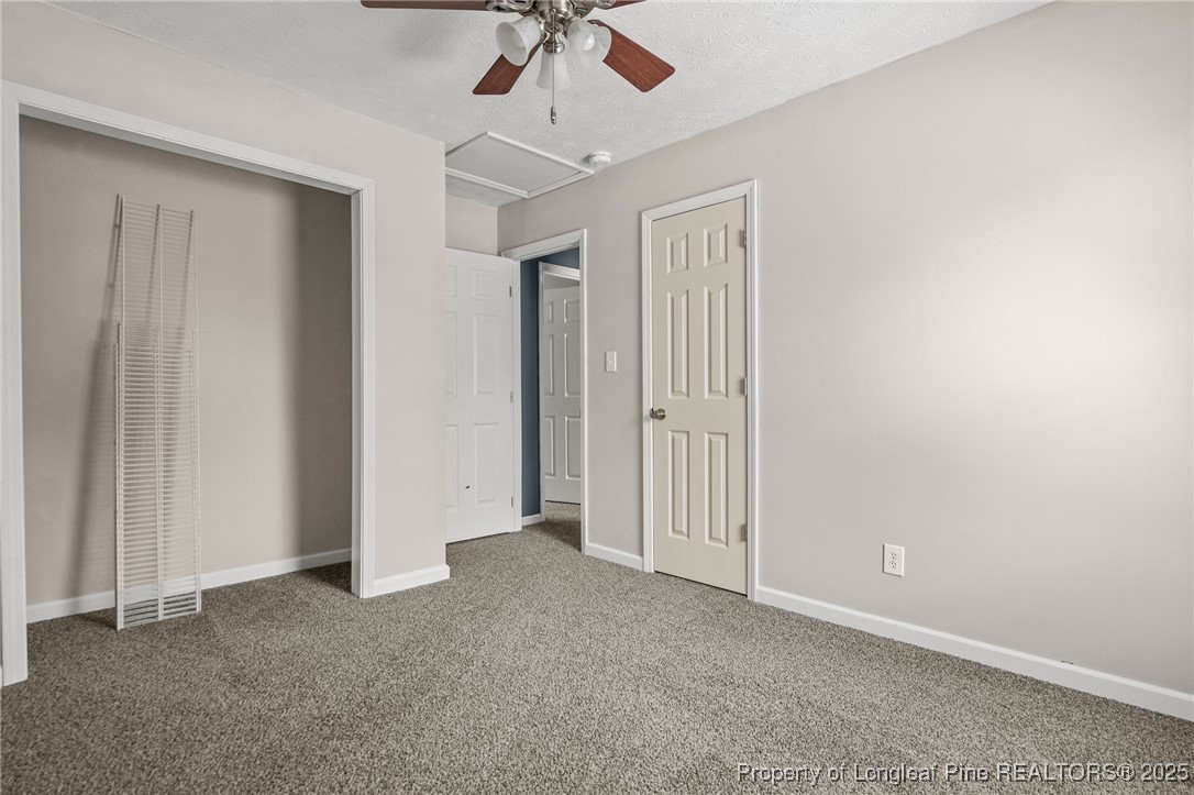 8810 Tangletree Drive Linden, NC 28356 - Photo 38 of 50 an empty room with a ceiling fan and carpet