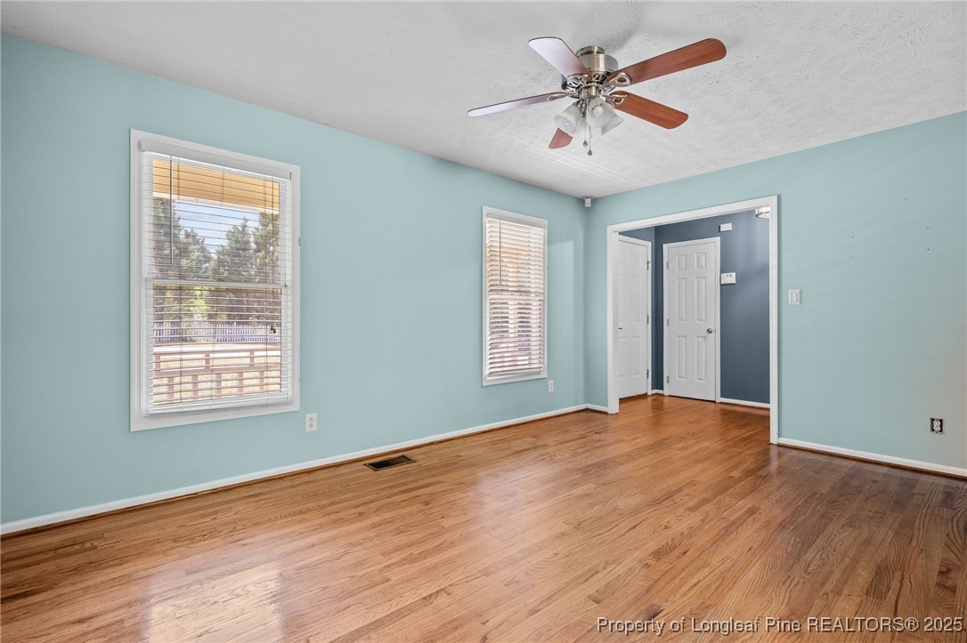 8810 Tangletree Drive Linden, NC 28356 - Photo 9 of 50 a view of an empty room with window and a chandelier fan