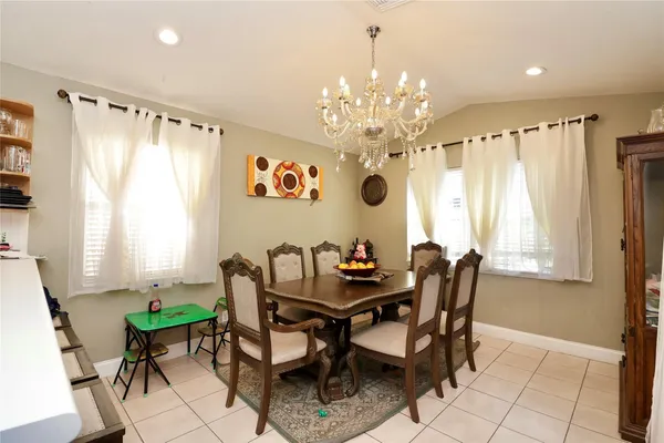 a view of a dining room with furniture and a chandelier