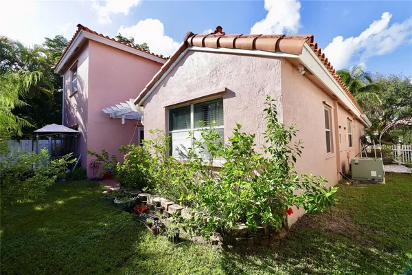 a view of a house with a yard and plants
