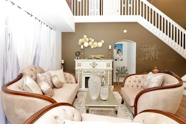 a living room with furniture and chandelier