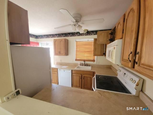 28 Commodore Cmns, Unit 28 Derby, CT 06418 - Photo 7 of 17 a kitchen with stainless steel appliances granite countertop a sink stove and refrigerator