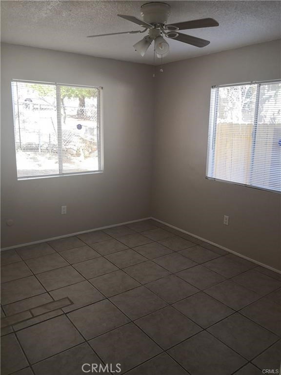 4217 Maple Trail Frazier Park, CA 93225 - Photo 8 of 12 an empty room with windows and fan