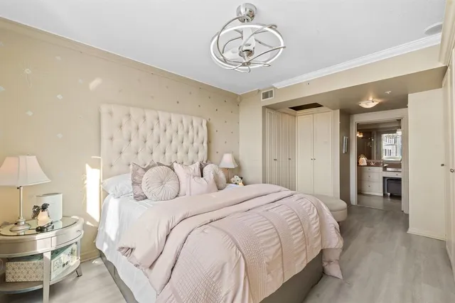a bedroom with a bed and a chandelier