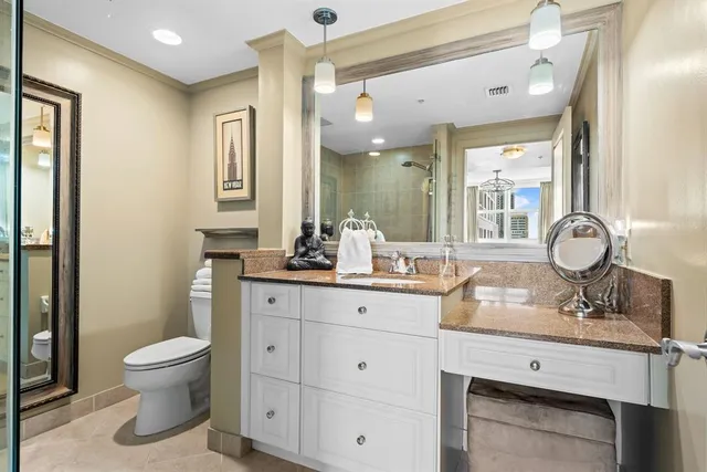 a bathroom with a toilet a sink and mirror