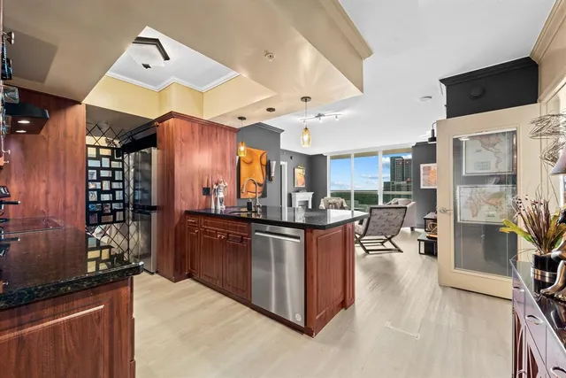 a kitchen with stainless steel appliances granite countertop a stove and a refrigerator