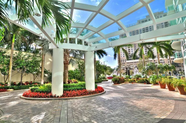 a view of a patio with table and chairs potted plants and palm trees