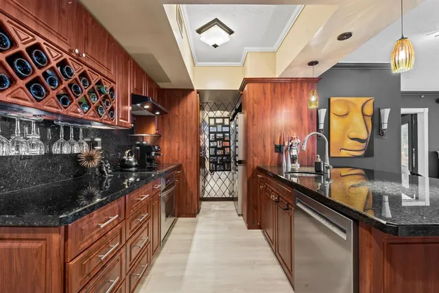 a kitchen with stainless steel appliances granite countertop a sink and stove