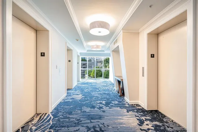 a view of a hallway with wooden floor and door