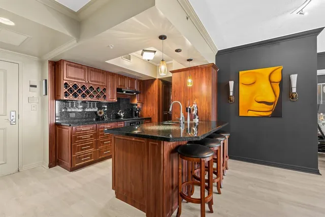 a kitchen with stainless steel appliances granite countertop a sink and cabinets