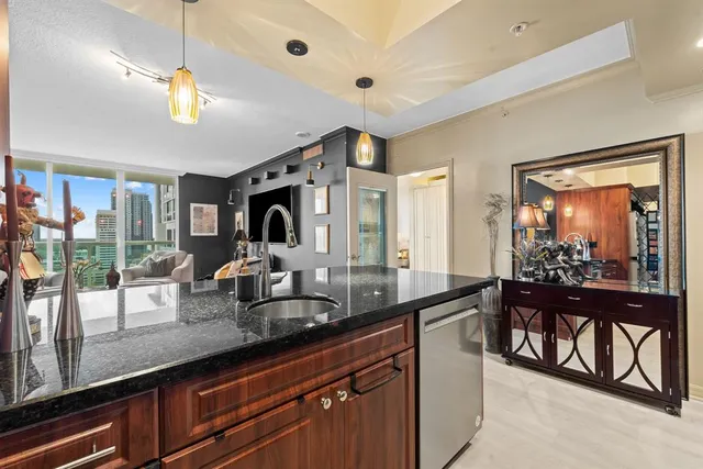 a kitchen with sink and view of living room