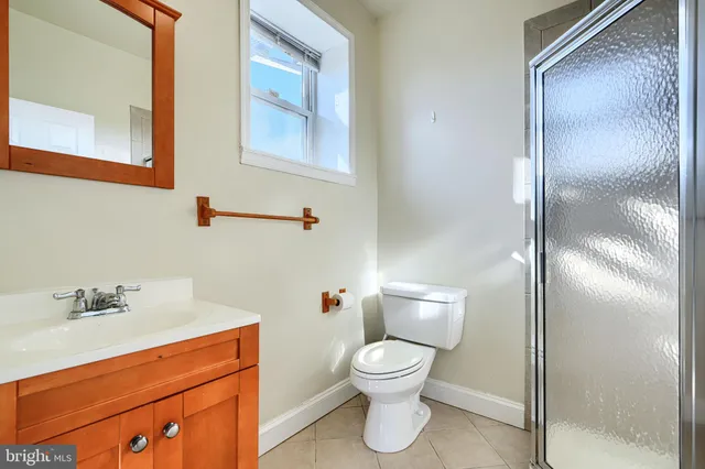 a white toilet sitting next to a bathroom sink