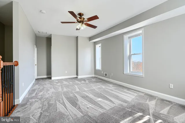 a view of a livingroom with a ceiling fan and window