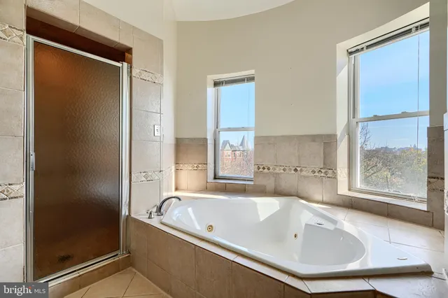 a bathroom with a tub and shower