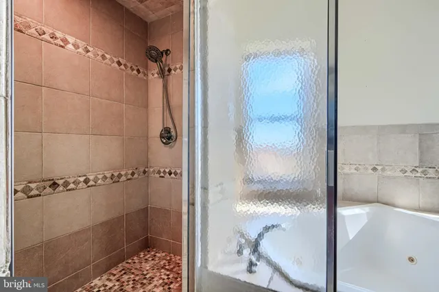 a bathroom with a glass shower door