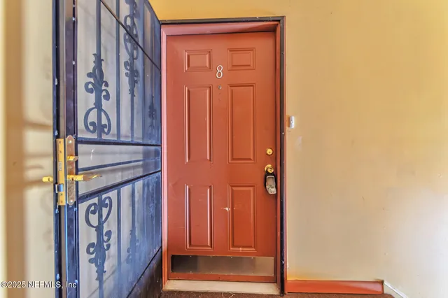 a view of front door with wooden door