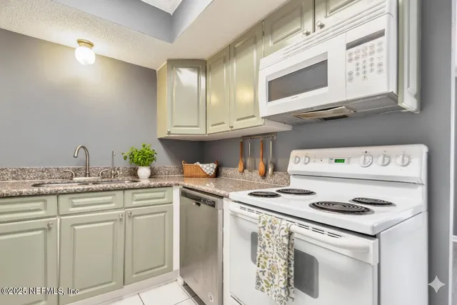 a kitchen with stainless steel appliances granite countertop a stove and a microwave