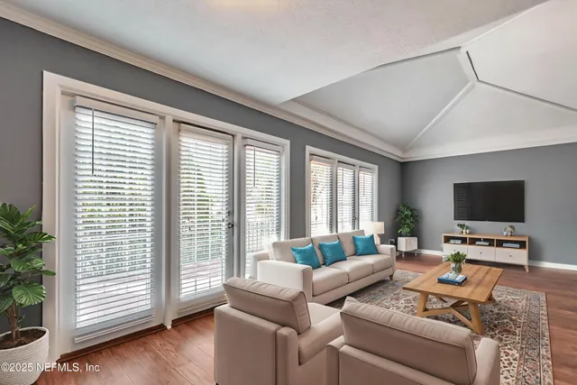 a living room with furniture and a flat screen tv