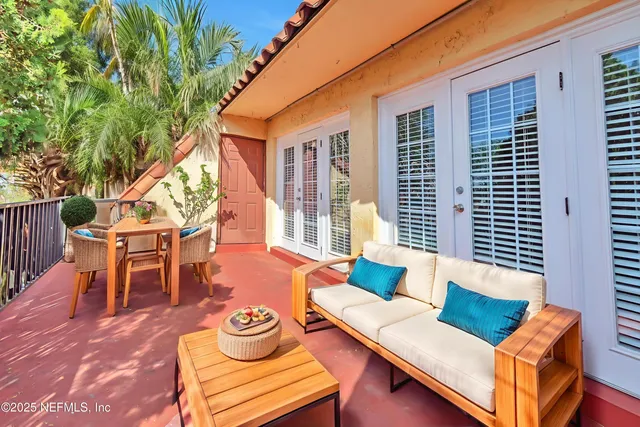 a view of a patio with couches chairs and a potted plant