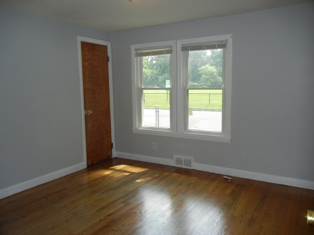 141 Freeman Terrace Springfield, MA 01104 - Photo 11 of 21 a view of an empty room with wooden floor and a window