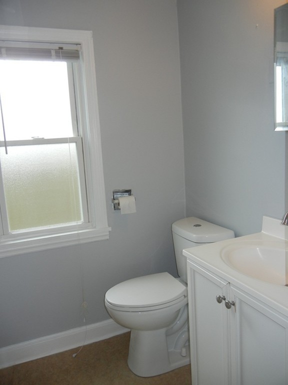 141 Freeman Terrace Springfield, MA 01104 - Photo 12 of 21 a white toilet sitting next to a window in a bathroom