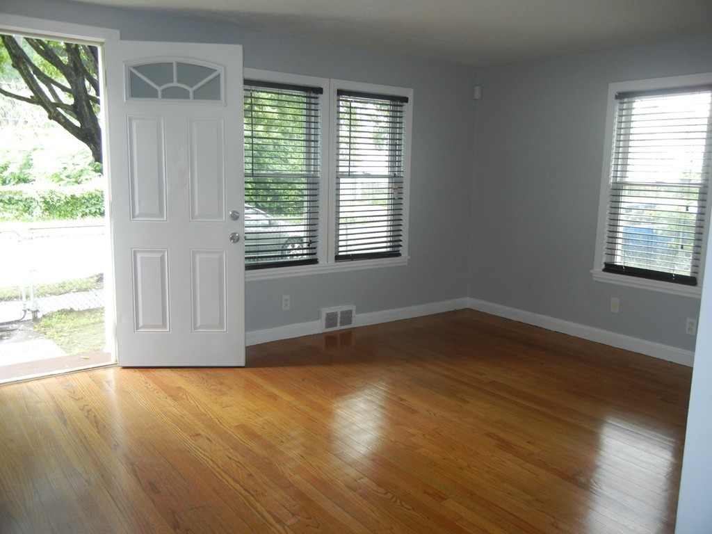 141 Freeman Terrace Springfield, MA 01104 - Photo 3 of 21 a view of an empty room with wooden floor and a window