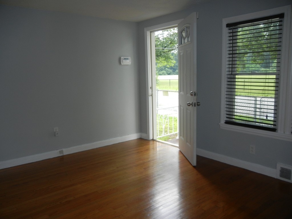 141 Freeman Terrace Springfield, MA 01104 - Photo 4 of 21 a view of an empty room with wooden floor and a window