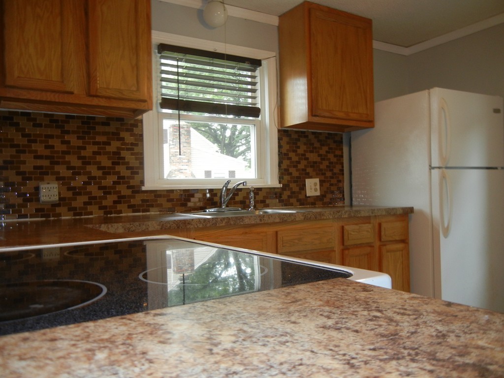 141 Freeman Terrace Springfield, MA 01104 - Photo 5 of 21 a kitchen with granite countertop a sink a stove and a refrigerator
